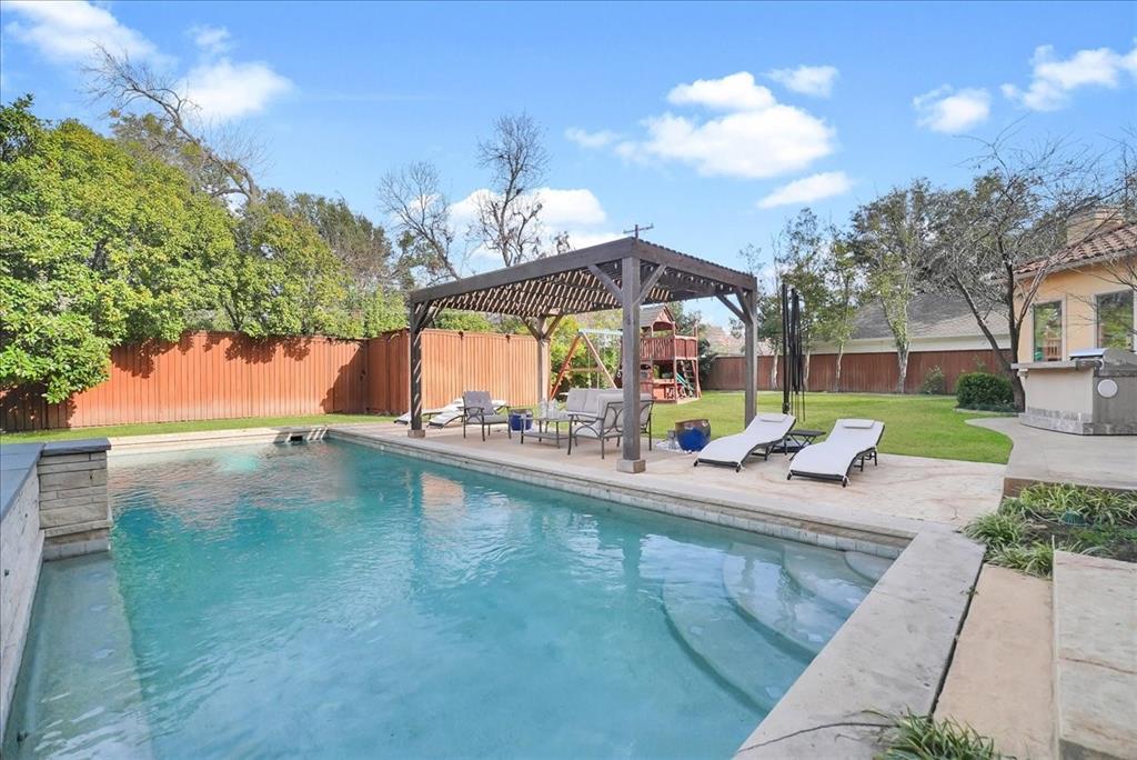 6807 Lupton Drive Dallas, TX 75225 - Photo 33 of 40 a view of a swimming pool with a patio