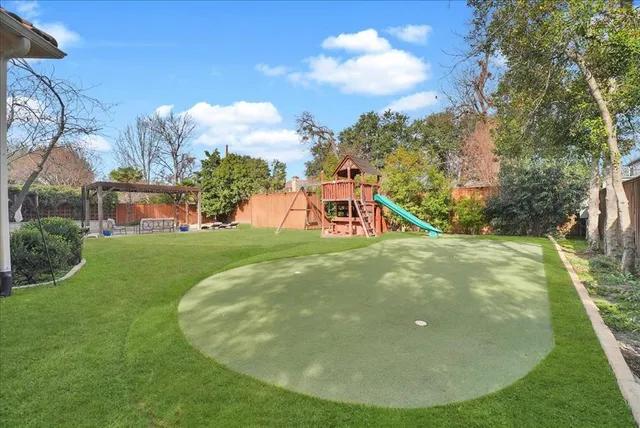 a view of a swimming pool with a yard
