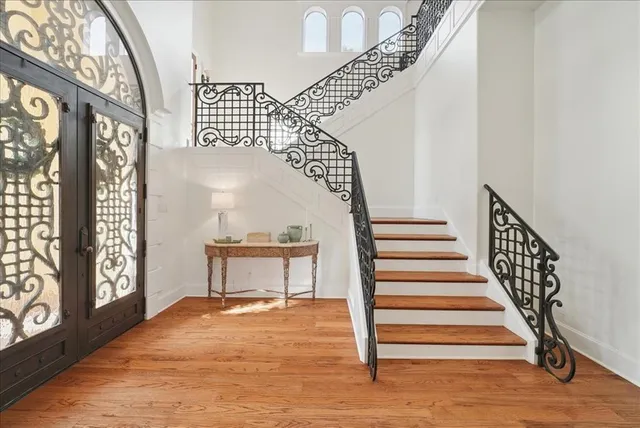 a view of entryway and hall with wooden floor