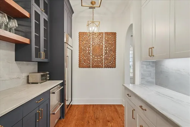 a kitchen with granite countertop white cabinets and white appliances