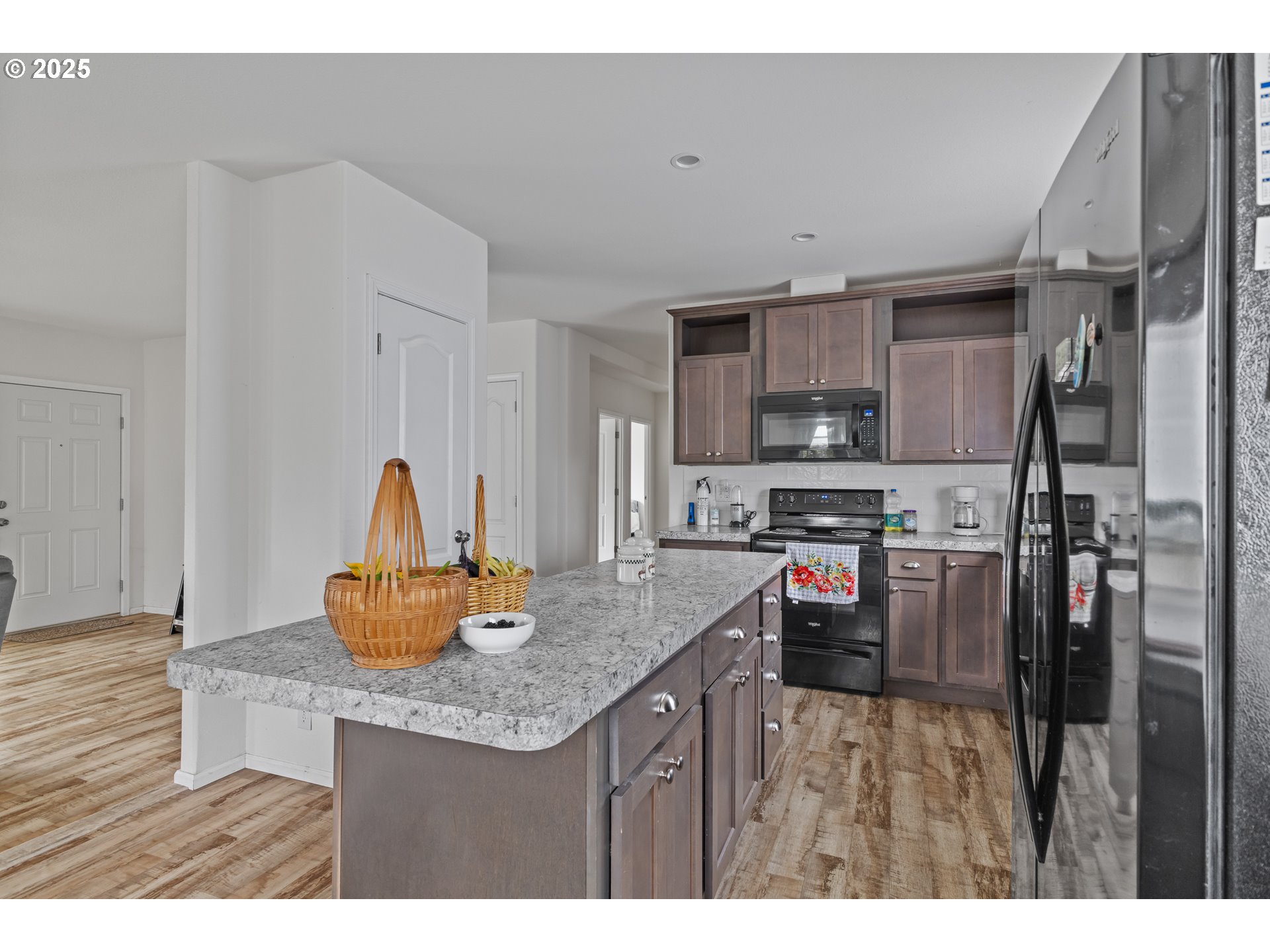 1873 East Cedar Street Myrtle Point, OR 97458 - Photo 13 of 27 a kitchen with stainless steel appliances granite countertop a sink refrigerator and cabinets