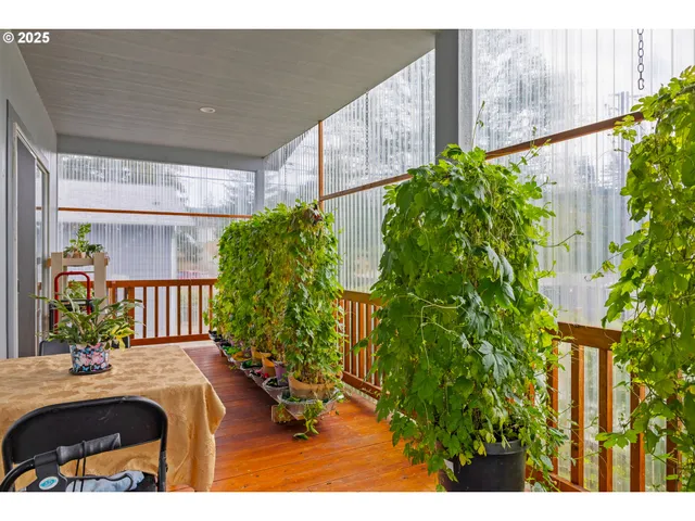 a balcony with potted plants and wooden fence