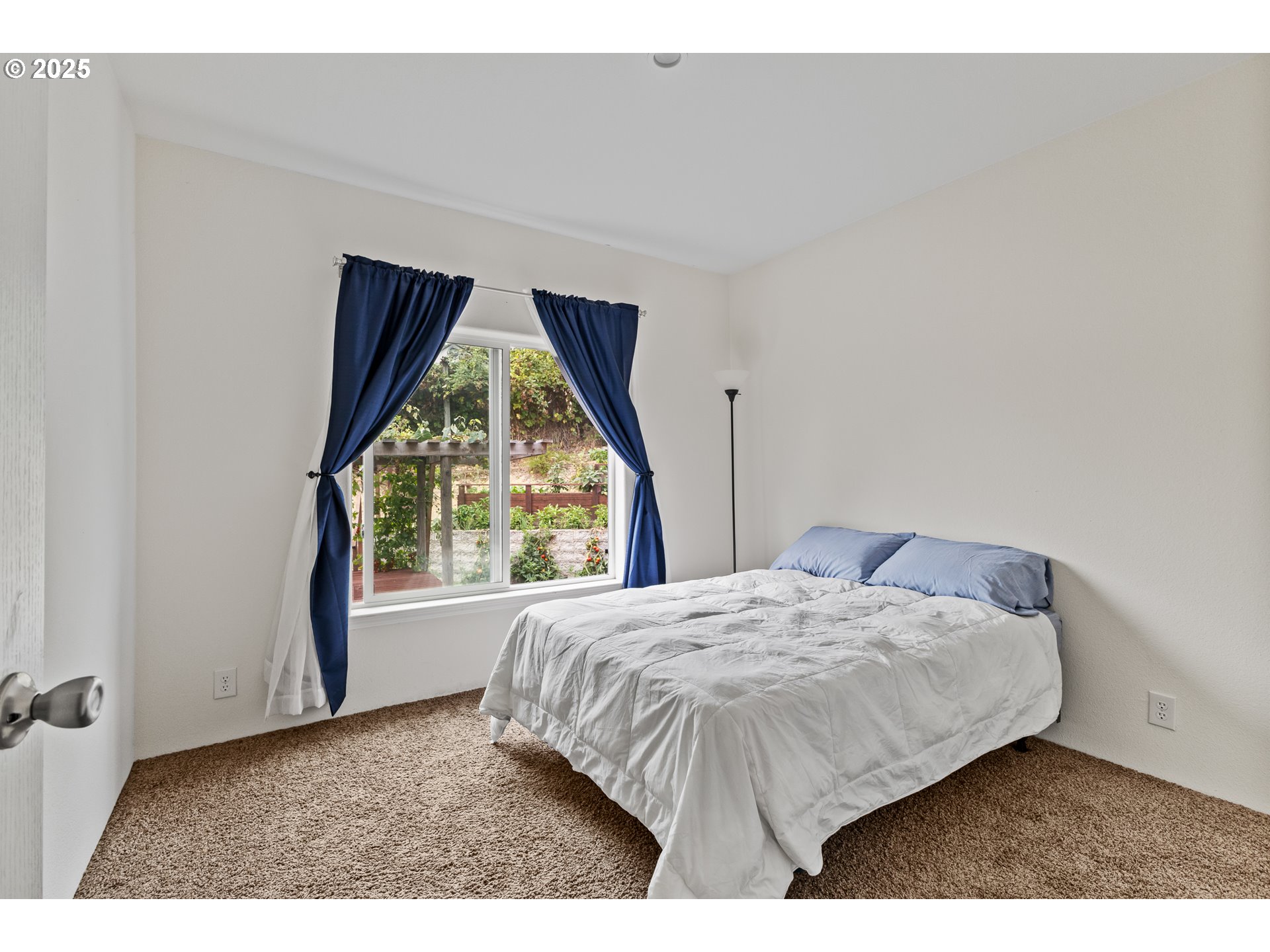 1873 East Cedar Street Myrtle Point, OR 97458 - Photo 22 of 27 a bedroom with a bed and a window