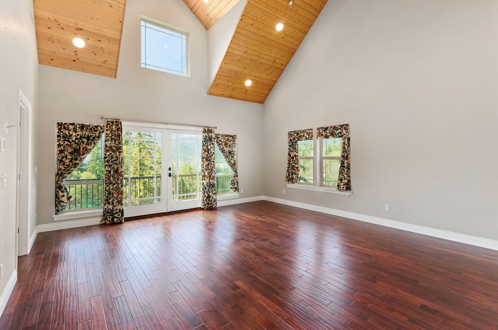 7304 North Applegate Road Grants Pass, OR 97527 - Photo 31 of 87 a view of an empty room with wooden floor and a window