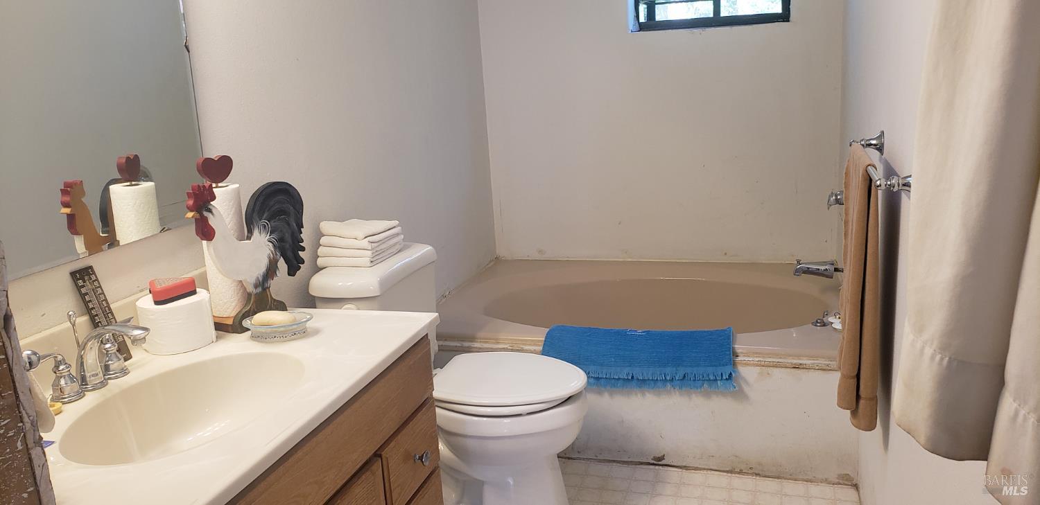 8312 Harrington Flat Road Middletown, CA 95461 - Photo 11 of 19 a bathroom with a sink a toilet and shower curtain
