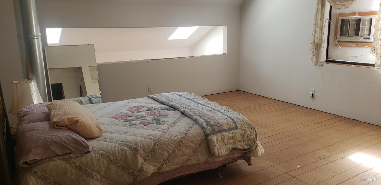 8312 Harrington Flat Road Middletown, CA 95461 - Photo 10 of 19 a bed sitting in a bedroom next to a window