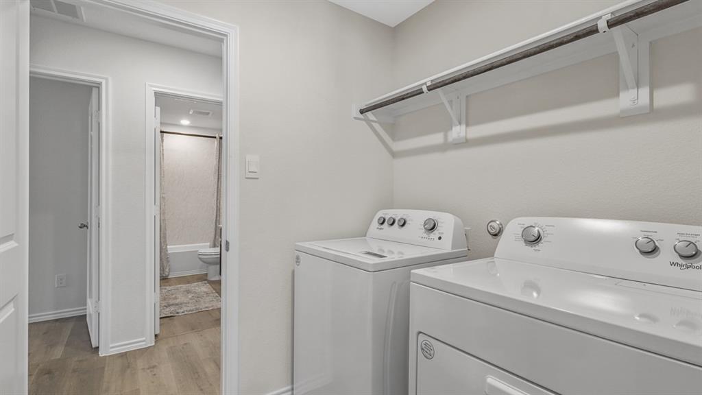 1667 Mantle Road Crandall, TX 75114 - Photo 19 of 20 Dedicated laundry area featuring a white top-load washer and front-load dryer