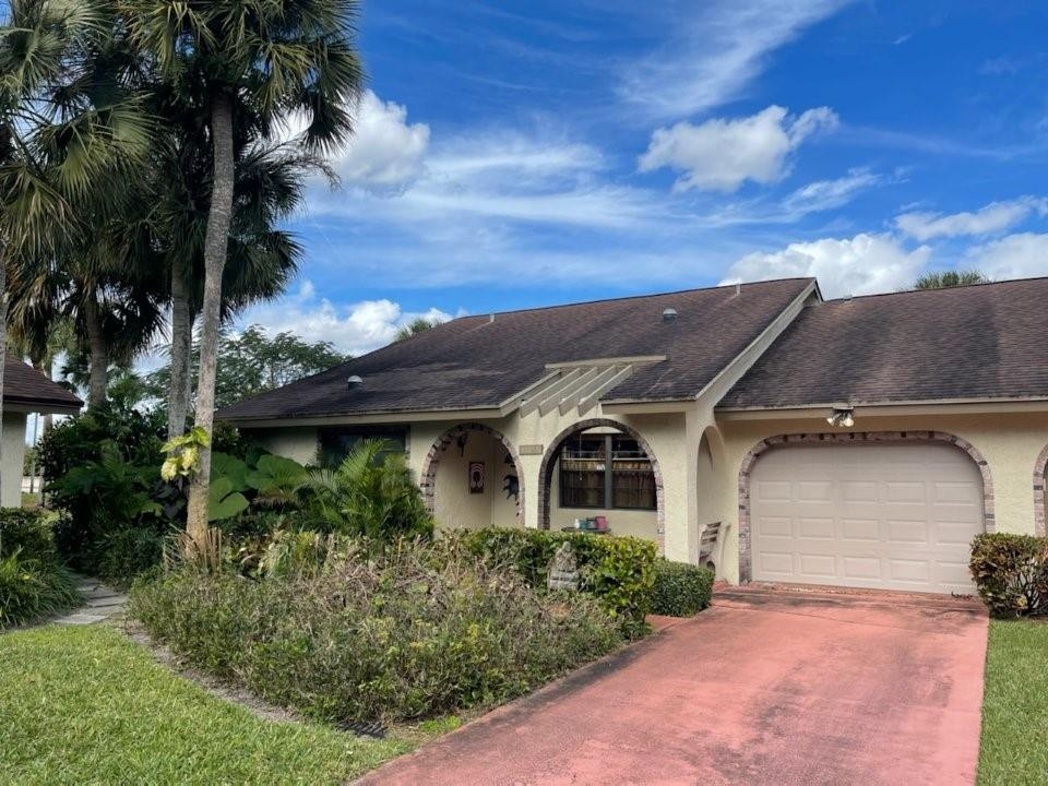 8837 Southwest 19th Street, Unit B Boca Raton, FL 33433 - Photo 1 of 1 a front view of a house with a yard
