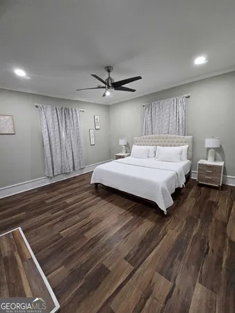 a spacious bedroom with a bed and a ceiling fan