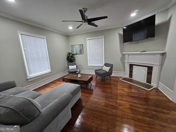 a living room with furniture a fireplace and a flat screen tv