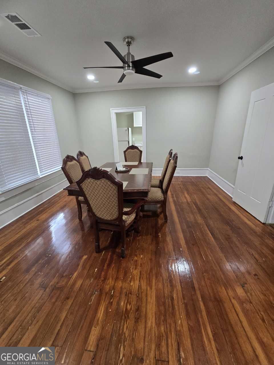 402 Meriwether Street Griffin, GA 30224 - Photo 22 of 38 a workspace room with wooden floor table and chairs
