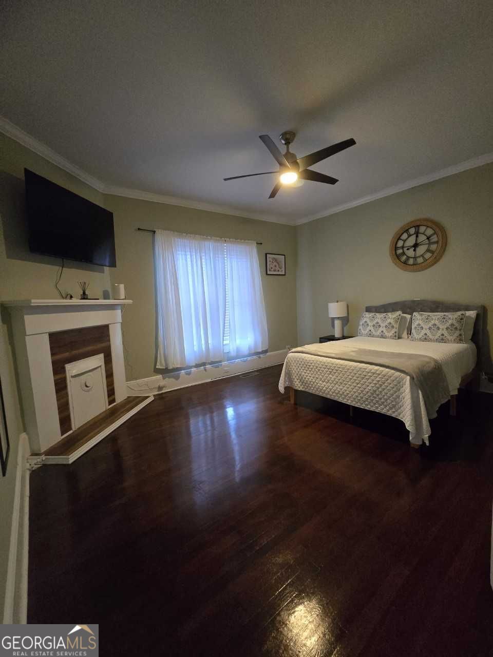 402 Meriwether Street Griffin, GA 30224 - Photo 10 of 38 a spacious bedroom with a bed and a flat screen tv