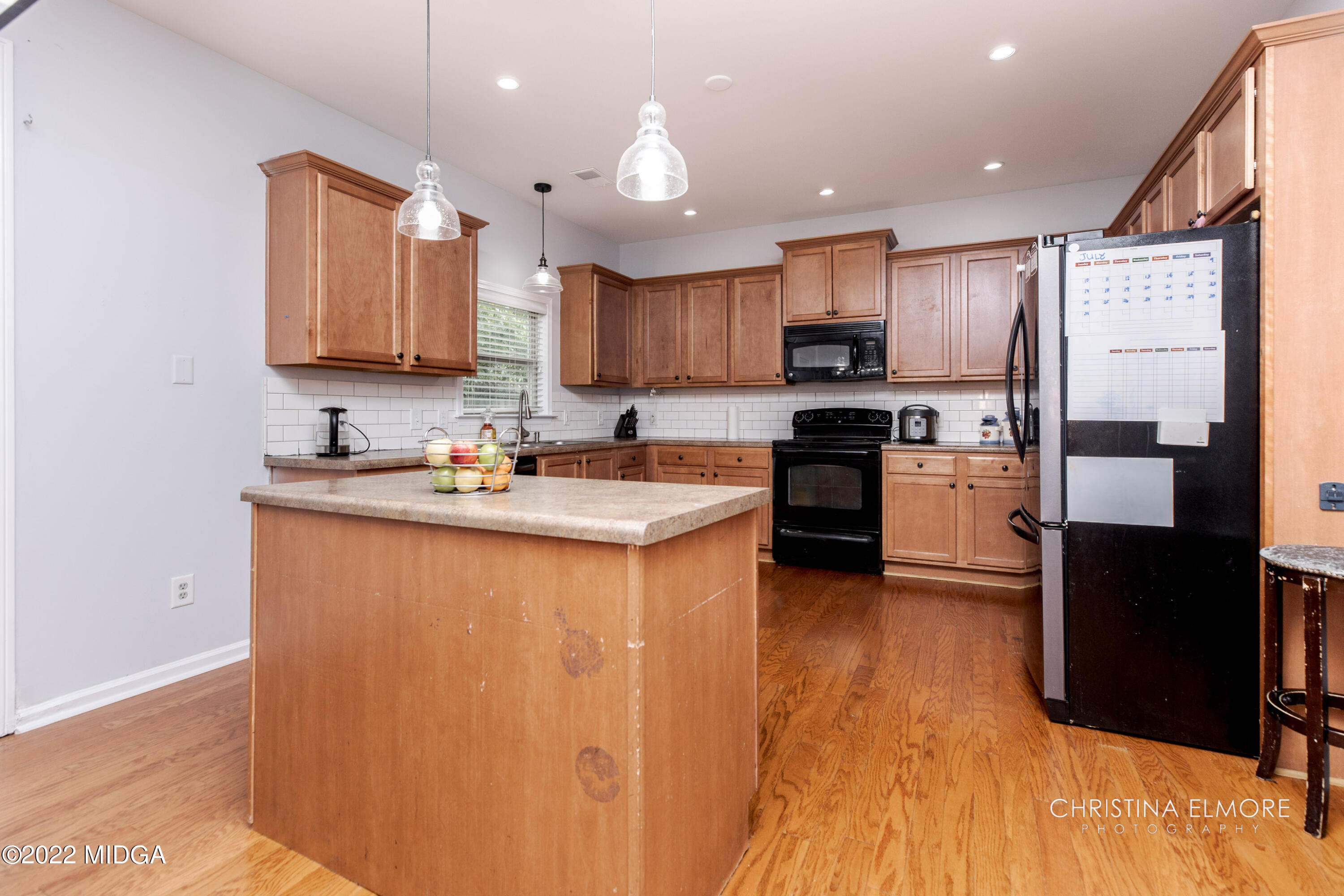 209 McEwen Court Perry, GA 31069 - Photo 11 of 39 a kitchen with stainless steel appliances granite countertop a refrigerator a sink dishwasher a stove and white cabinets with wooden floor