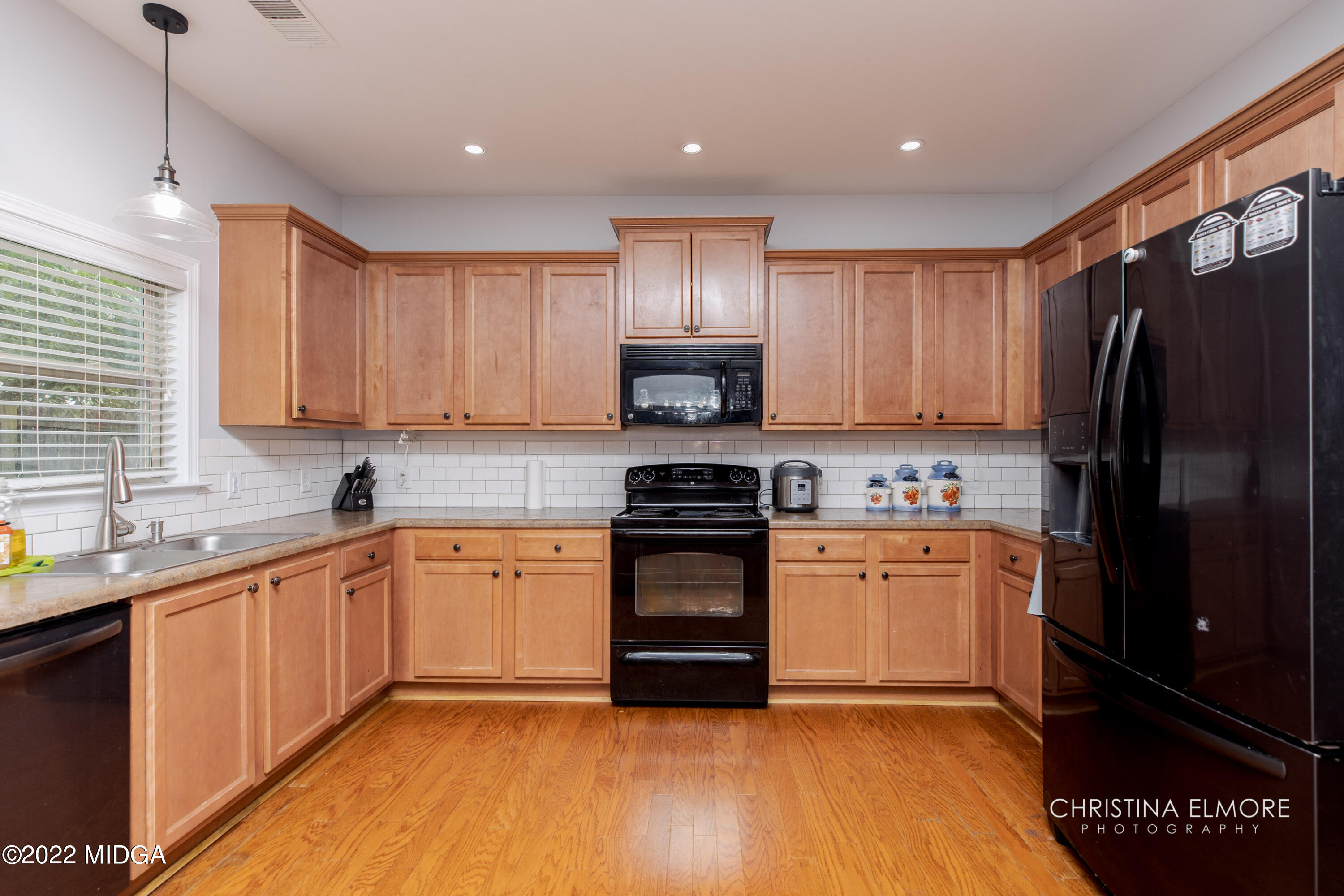 209 McEwen Court Perry, GA 31069 - Photo 13 of 39 a kitchen with stainless steel appliances granite countertop a refrigerator a sink dishwasher a stove and white cabinets with wooden floor