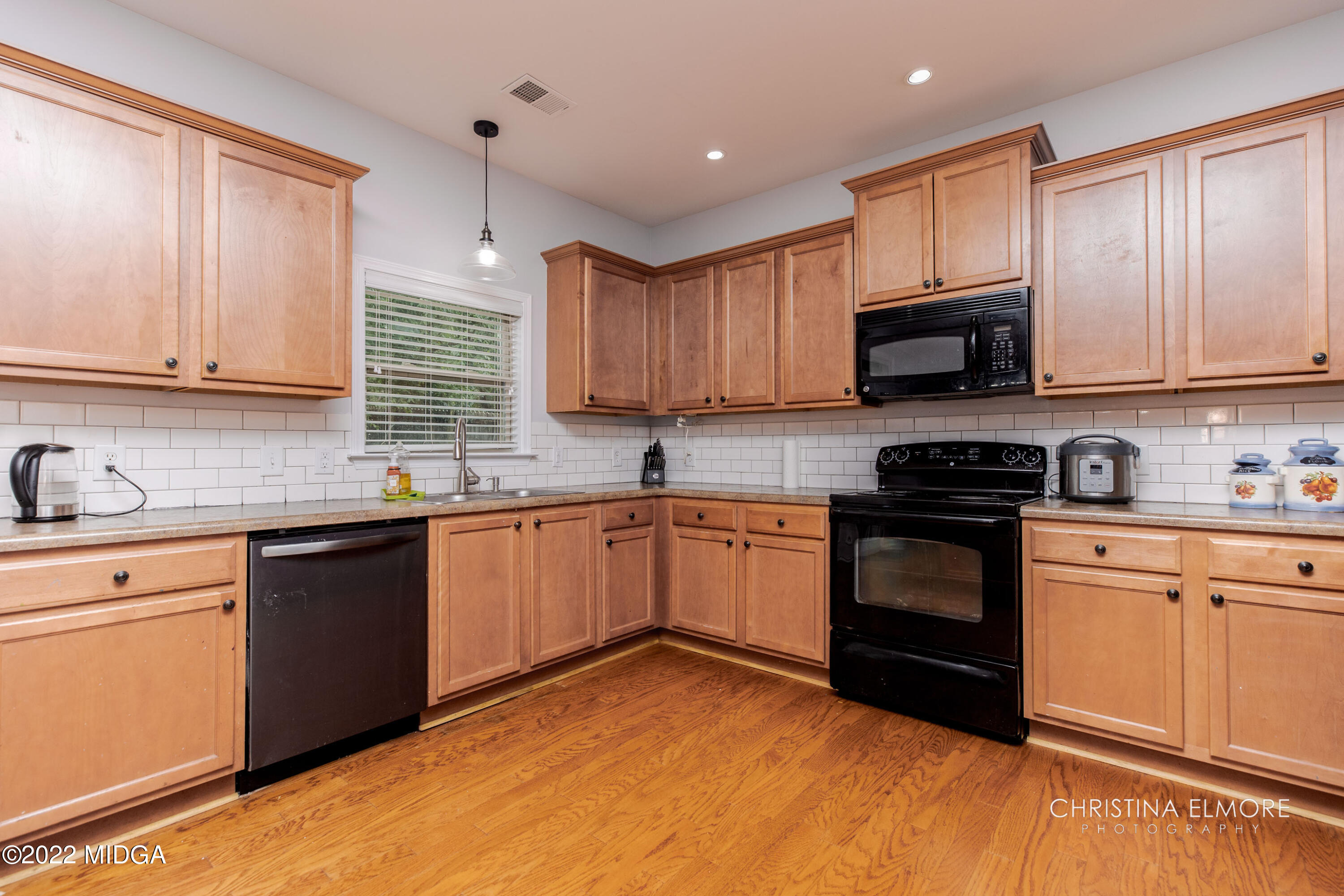 209 McEwen Court Perry, GA 31069 - Photo 15 of 39 a kitchen with granite countertop a sink cabinets and stainless steel appliances