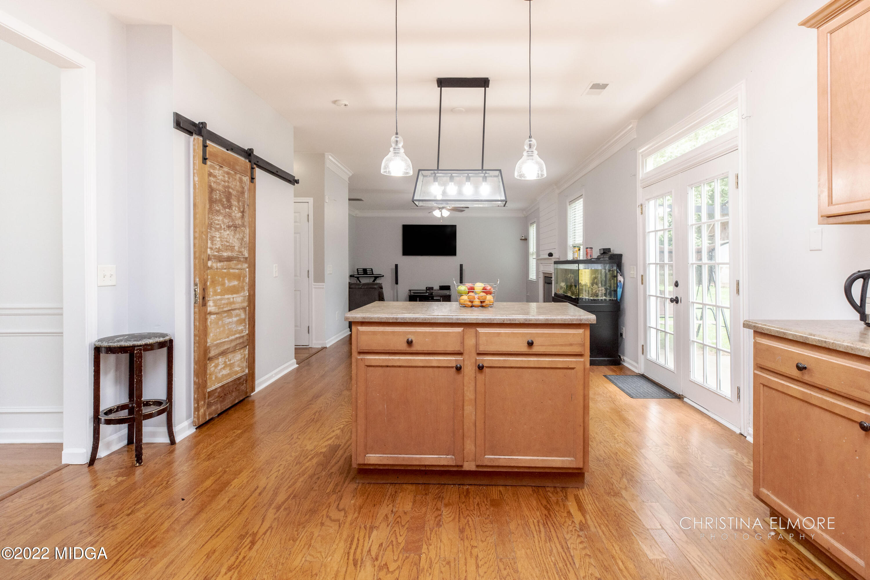 209 McEwen Court Perry, GA 31069 - Photo 16 of 39 a kitchen with kitchen island wooden floors and stainless steel appliances