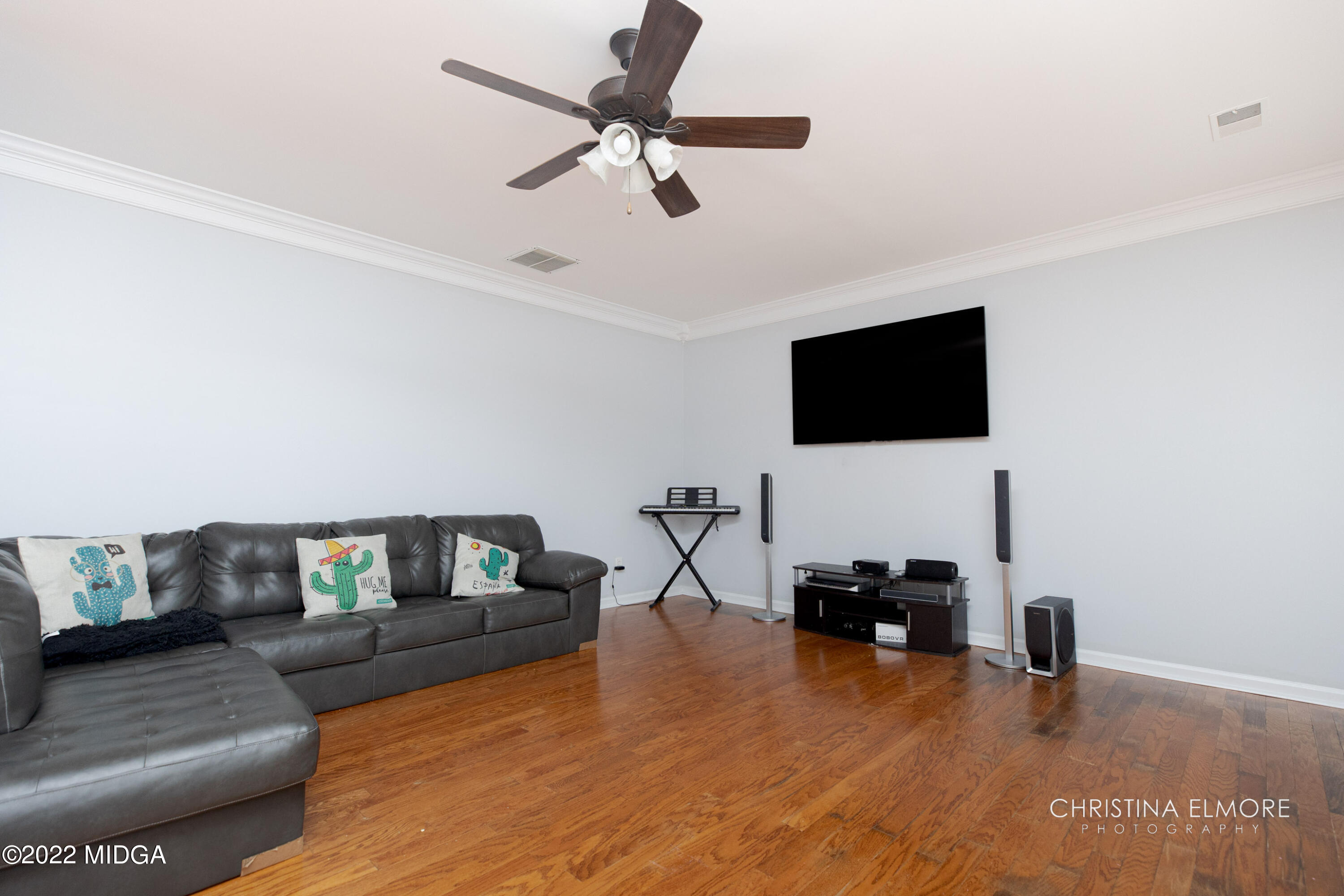 209 McEwen Court Perry, GA 31069 - Photo 17 of 39 a living room with furniture and a flat screen tv