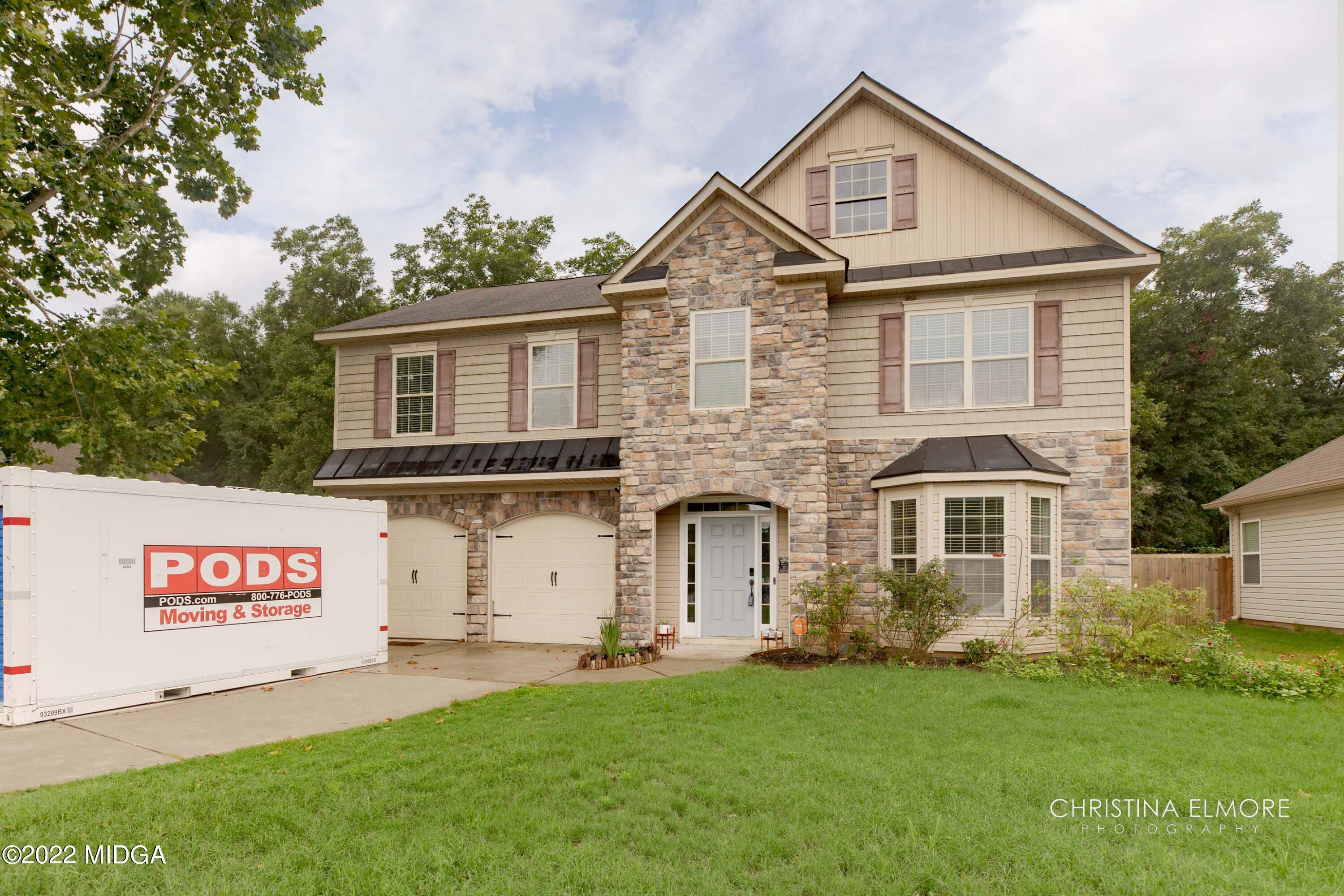 209 McEwen Court Perry, GA 31069 - Photo 2 of 39 a front view of a house with a garden and yard