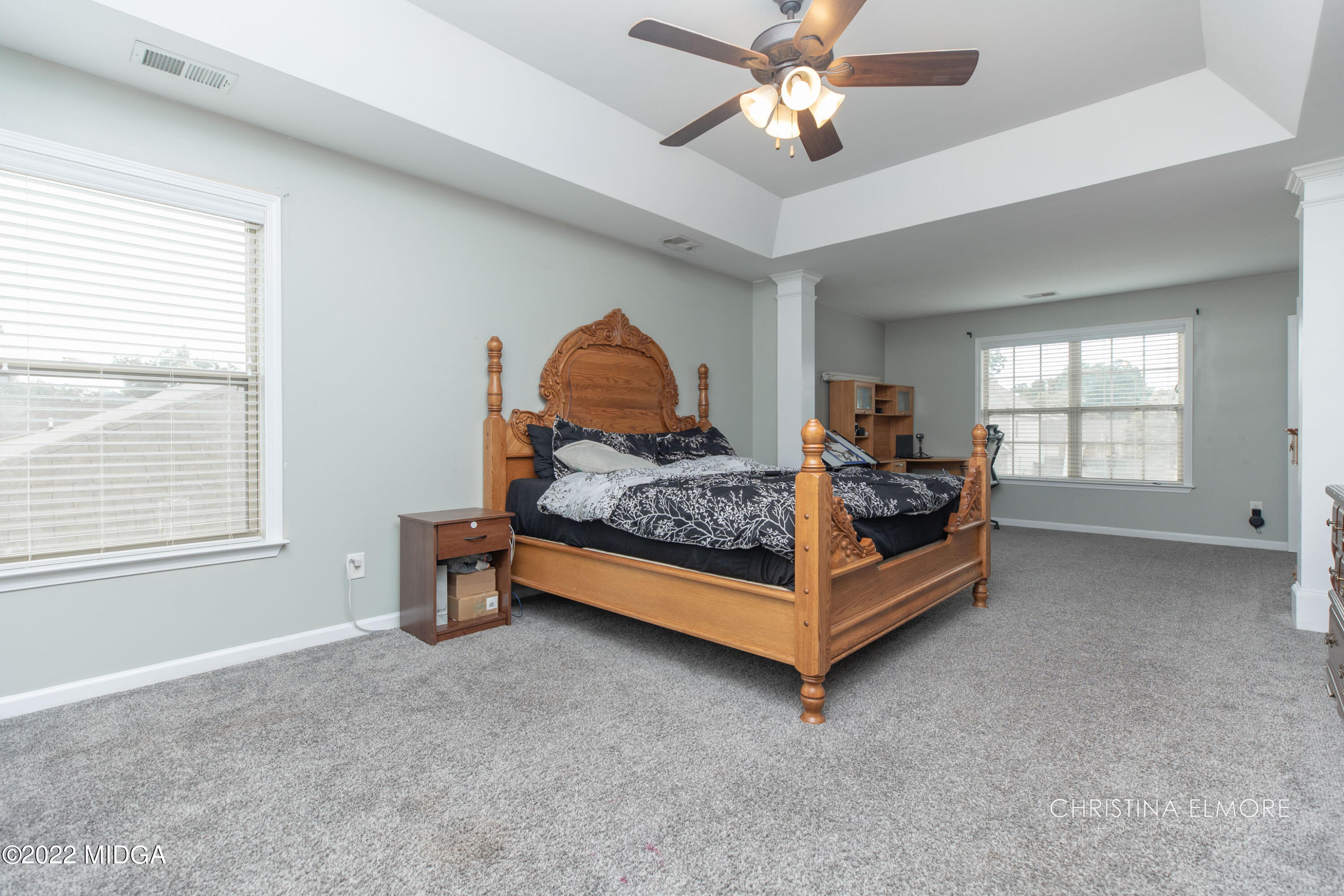 209 McEwen Court Perry, GA 31069 - Photo 24 of 39 a bedroom with a bed and a chandelier
