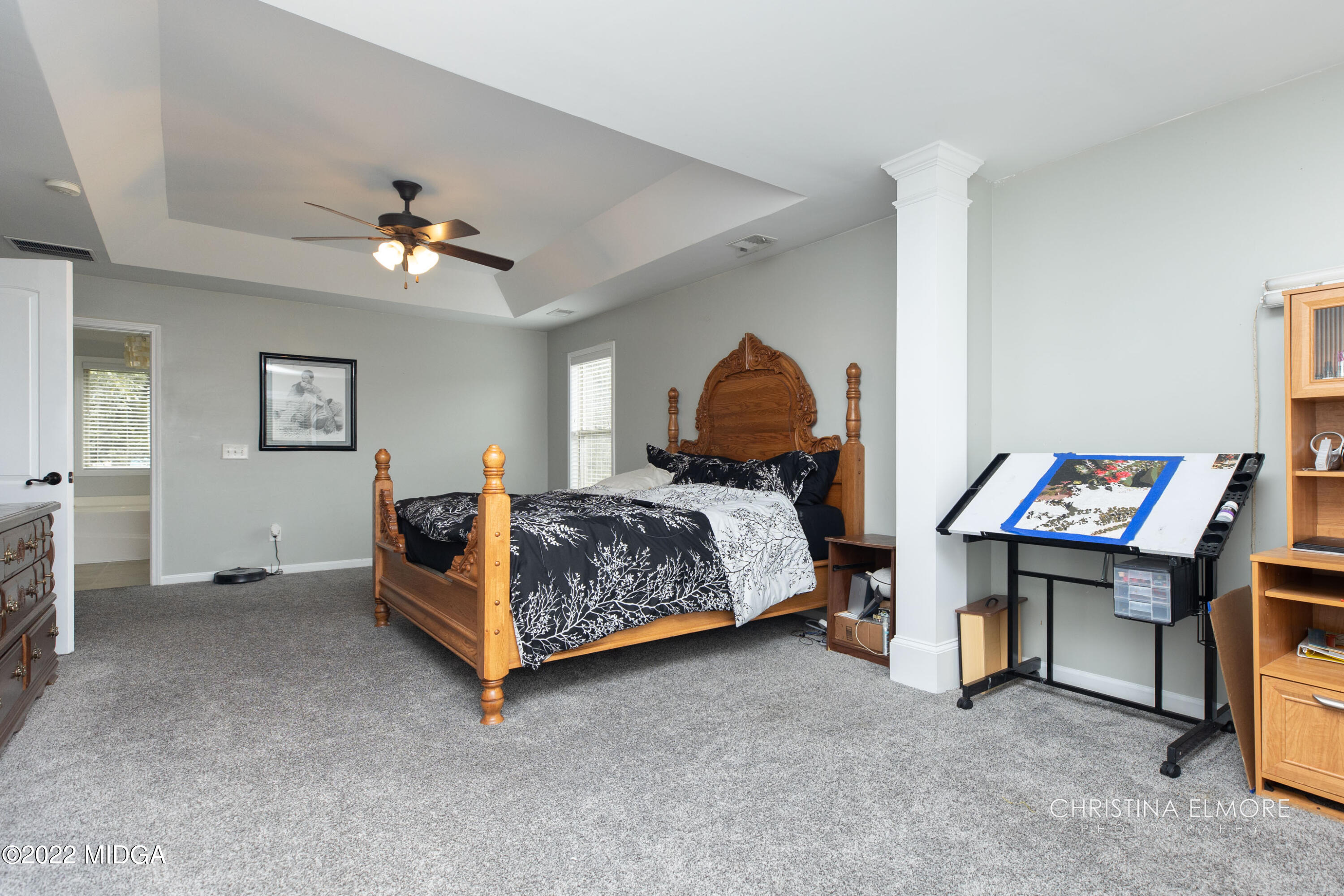 209 McEwen Court Perry, GA 31069 - Photo 25 of 39 a bedroom with a bed and a chandelier