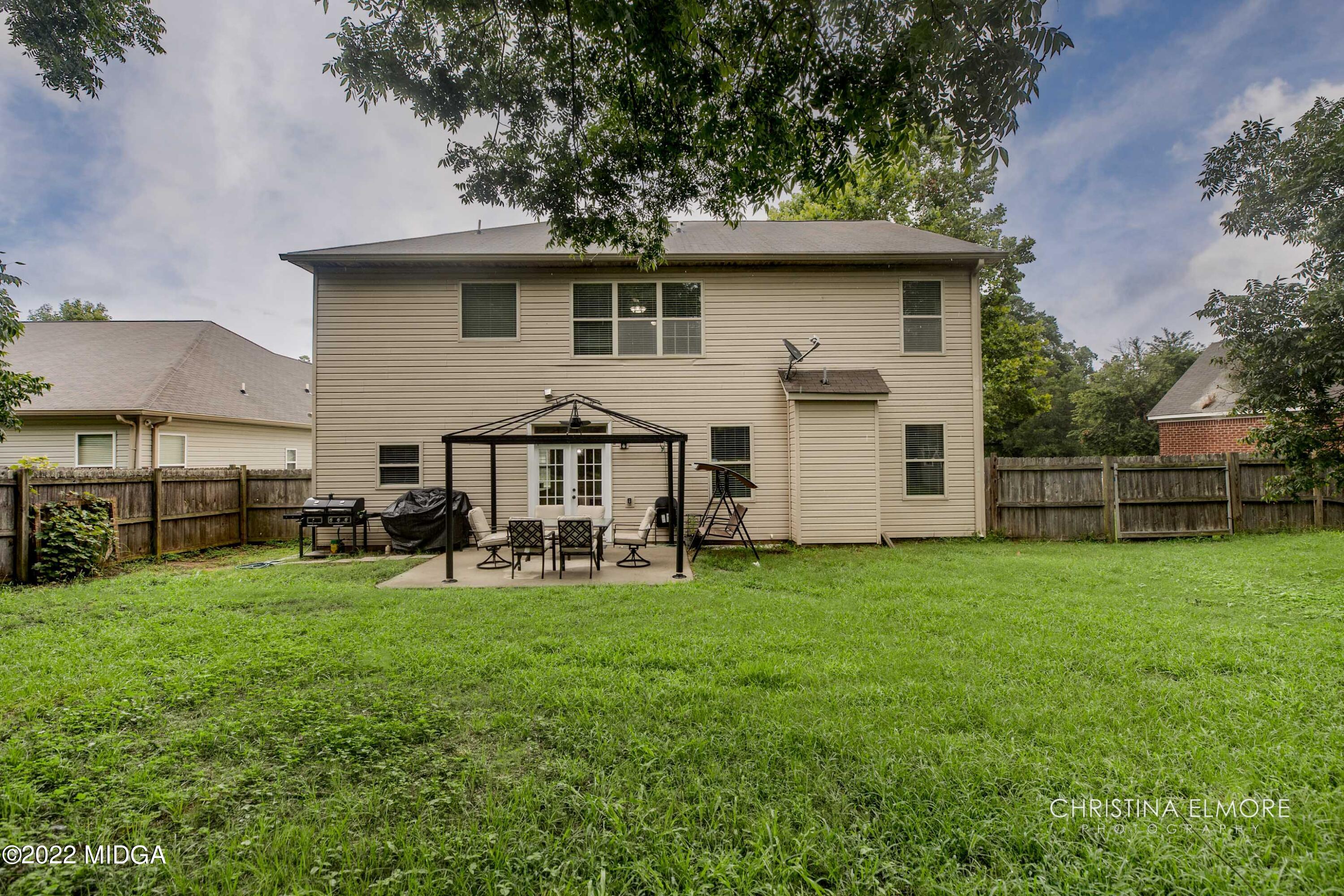 209 McEwen Court Perry, GA 31069 - Photo 36 of 39 a view of a house with backyard sitting area and garden