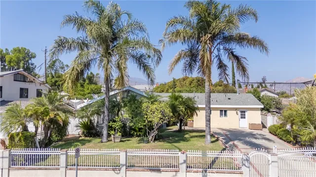a view of houses with palm trees