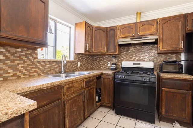 a kitchen with stainless steel appliances granite countertop a sink stove and cabinets