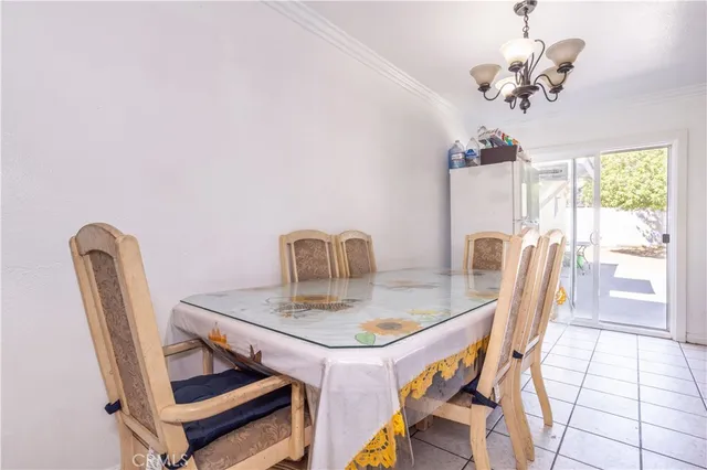 a view of a dining room with furniture and a chandelier