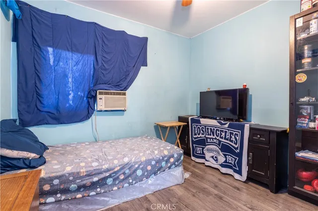 a bedroom with a bed and flat screen tv
