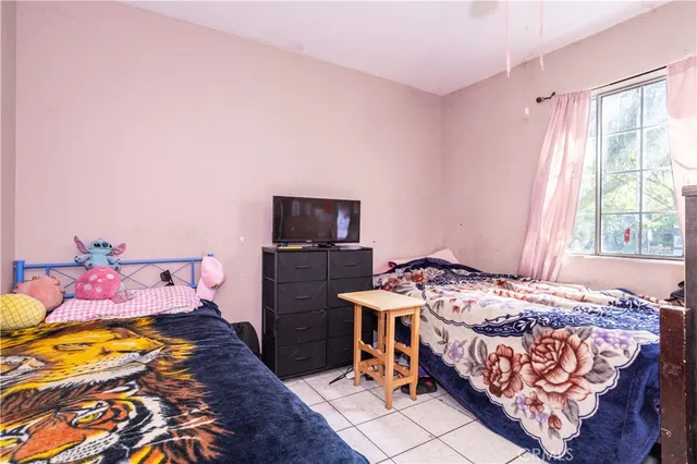 a bedroom with a bed and a tv