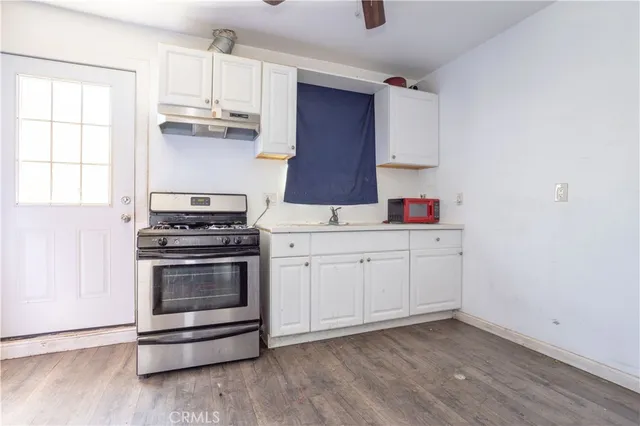 a kitchen with appliances cabinets and a window
