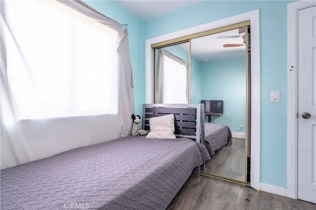 a bedroom with a bed and a mirror