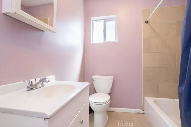 a white toilet sitting next to a bathroom sink