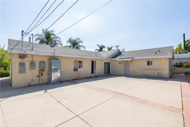 a view of a house with potted plants