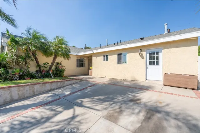 a view of a house with a backyard and a garage