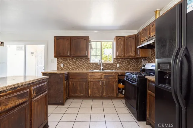 a kitchen with a sink stove and refrigerator