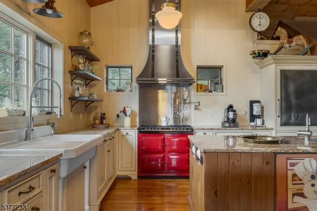 a kitchen with stainless steel appliances granite countertop a sink dishwasher stove and cabinets