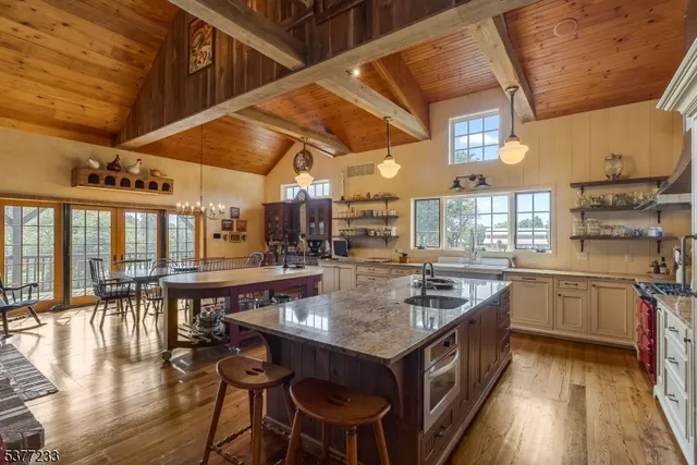 a kitchen with stainless steel appliances granite countertop a stove and a wooden cabinets