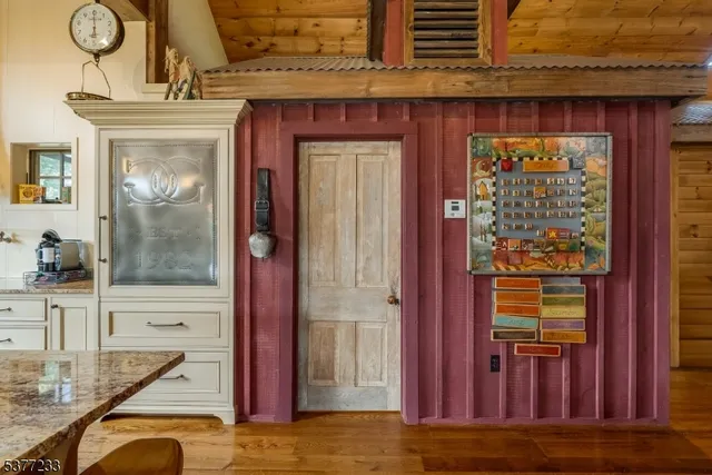 a view of an entryway with wooden floor and door