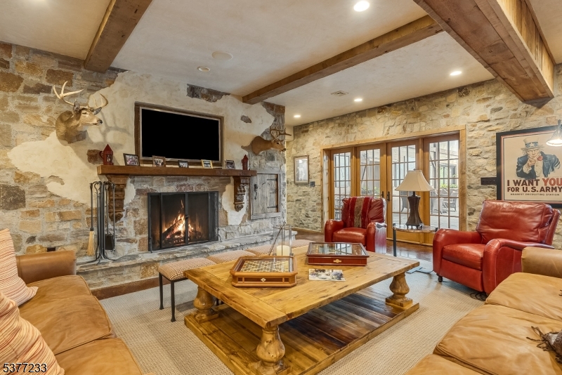 106 Mountain Top Road Glen Gardner, NJ 08826 - Photo 31 of 48 a living room with furniture a flat screen tv and a fireplace