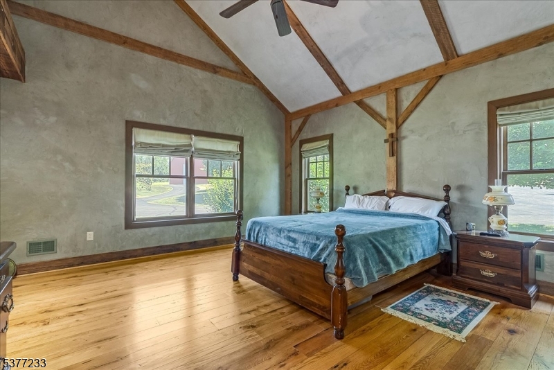 106 Mountain Top Road Glen Gardner, NJ 08826 - Photo 38 of 48 a bedroom with a bed lamp and a large window