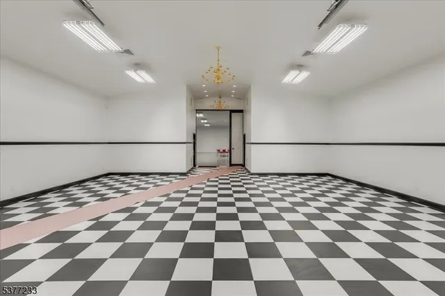 a room with lots of cars parked on the road