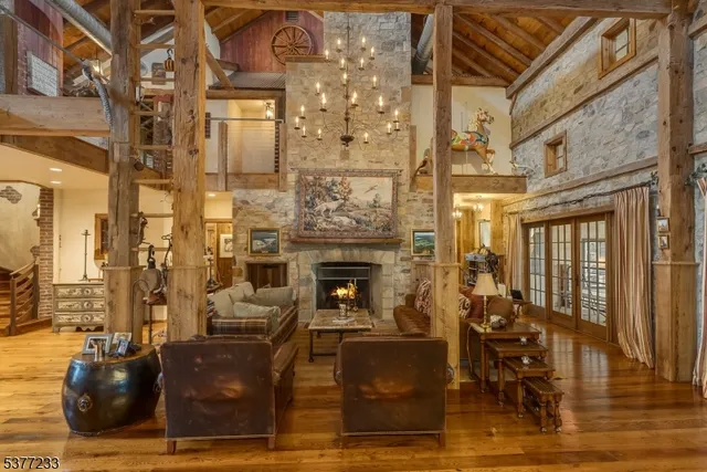 a living room with couches chairs and fireplace