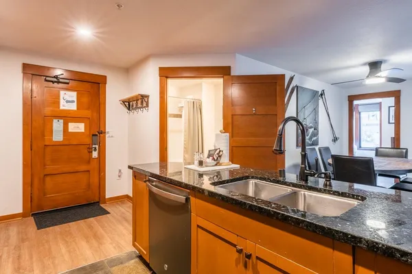 a bathroom with a granite countertop sink and a mirror
