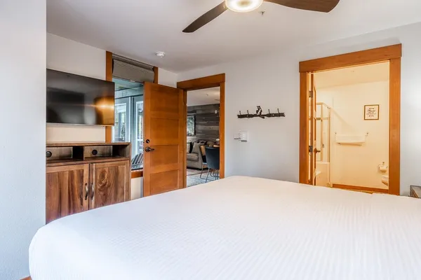 a bedroom with a bed and a large mirror