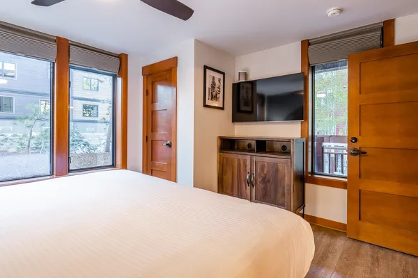 a bedroom with a bed and a flat screen tv