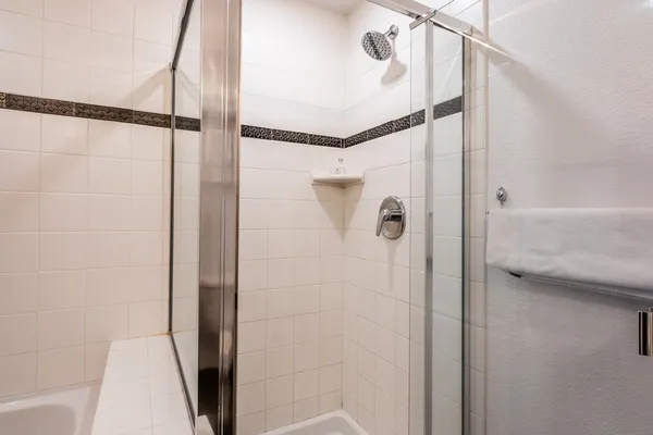 a bathroom with a shower and a glass door