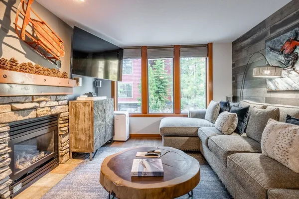 a living room with furniture and a fireplace