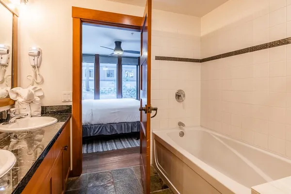 a en suite bathroom with a tub shower and sink