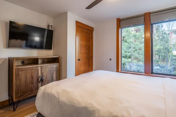 a bedroom with a bed and a flat screen tv